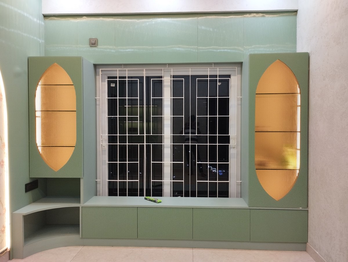 Custom green TV unit with oval glass cabinets